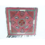 An antique Chinese tablecloth laid to a frame