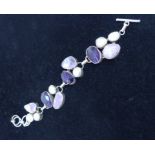 A chunky, sterling silver bracelet set with large rose quartz, amethyst and pearls