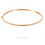 An 18 ct rose gold and diamond bangle by Theo Fennel