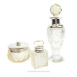 Two silver and cut glass scent bottles and a dressing table jar