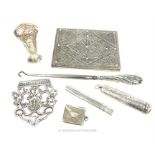 A collection of silver items including a card case