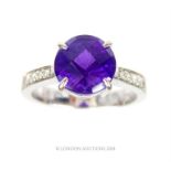 A chunky, 18 ct white gold, diamond and large amethyst ring