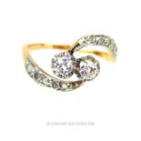 An 18 ct and platinum, Art Nouveau, two diamond, cross over ring