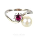 An 18 ct white gold, ruby, pearl and diamond, cross-over ring