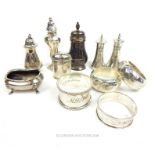 A collection of sterling silver cruets and napkin rings