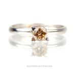 Tested as 18 ct white gold and champagne-coloured, diamond, solitaire ring