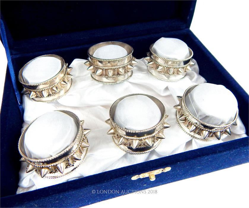 A cased set of six Oman sterling silver bangle design napkin rings