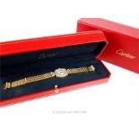 Cartier - A boxed, 18 ct yellow gold, Cartier, diamond set Tonneau bracelet watch