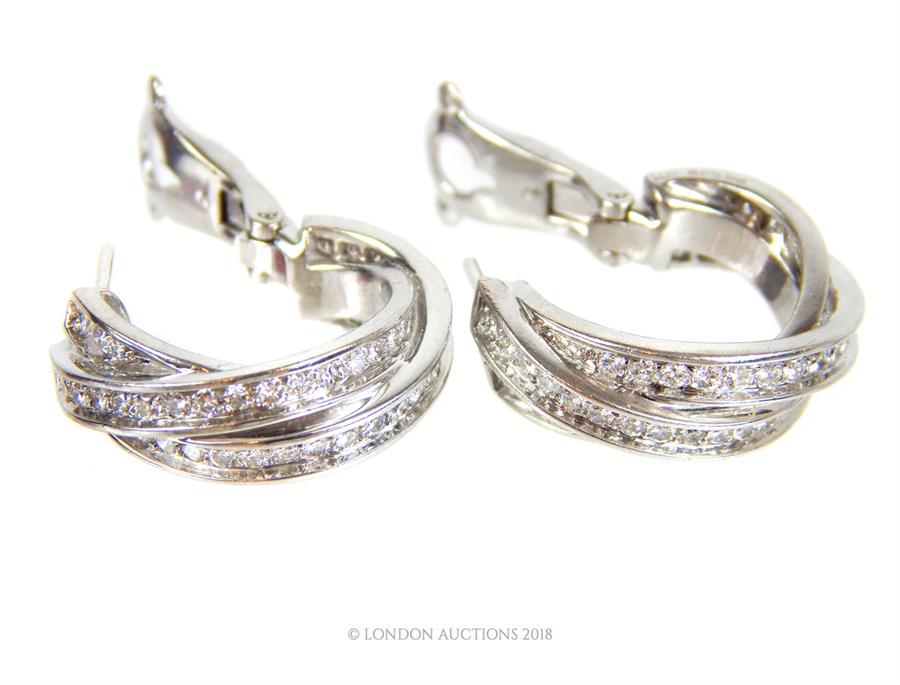 A boxed, pair of 18 ct white gold, diamond hoop 'Trinity' earrings - Image 2 of 3