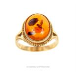 A 9 ct yellow gold and natural amber, cabochon ring