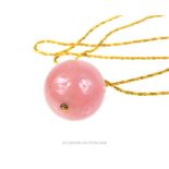 An 18 ct yellow gold rope-twist chain and spherical, rose-quartz pendant