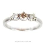 An 18 ct white gold, three stone diamond ring