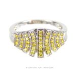 An 18 ct white gold ring studded with fancy, yellow-coloured diamonds