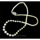 A platinum and diamond clasped, Art Deco, natural pearl graduated necklace