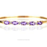 A 10 ct yellow gold, amethyst and diamond, hinged, bangle