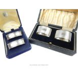 Two cased pairs of sterling silver napkin rings