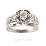 An 18 ct white gold, French, diamond ring