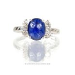 An 18 ct white gold, diamond and sapphire cabochon ring