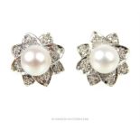 A pair of 18 ct white gold, French, diamond and Akoya pearl flower earrings