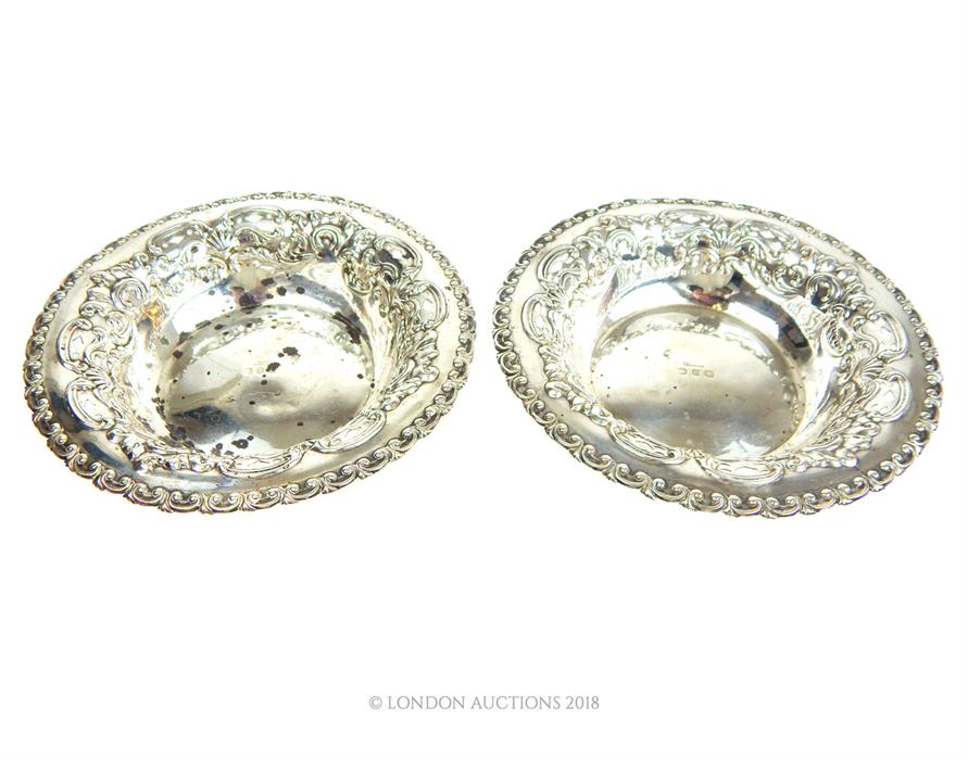 A pair of sterling silver circular bonbon dishes