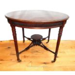A fine, mahogany, circular, Queen Anne-style, centre table on four brass casters