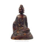 A Chinese, metal, seated female Buddha with traces of gilding