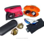 Four designer sunglasses with cases