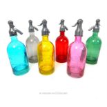 A set of six coloured glass models of soda syphons