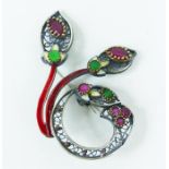 A white metal brooch, having filigree work, green and red stones