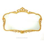 A 19th century style gilt framed mirror of modern manufacture; overall 85cm x 58cm.