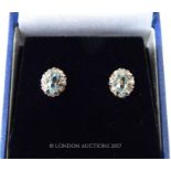 A boxed pair of 9 ct yellow and white gold, diamond and aquamarine stud earrings
