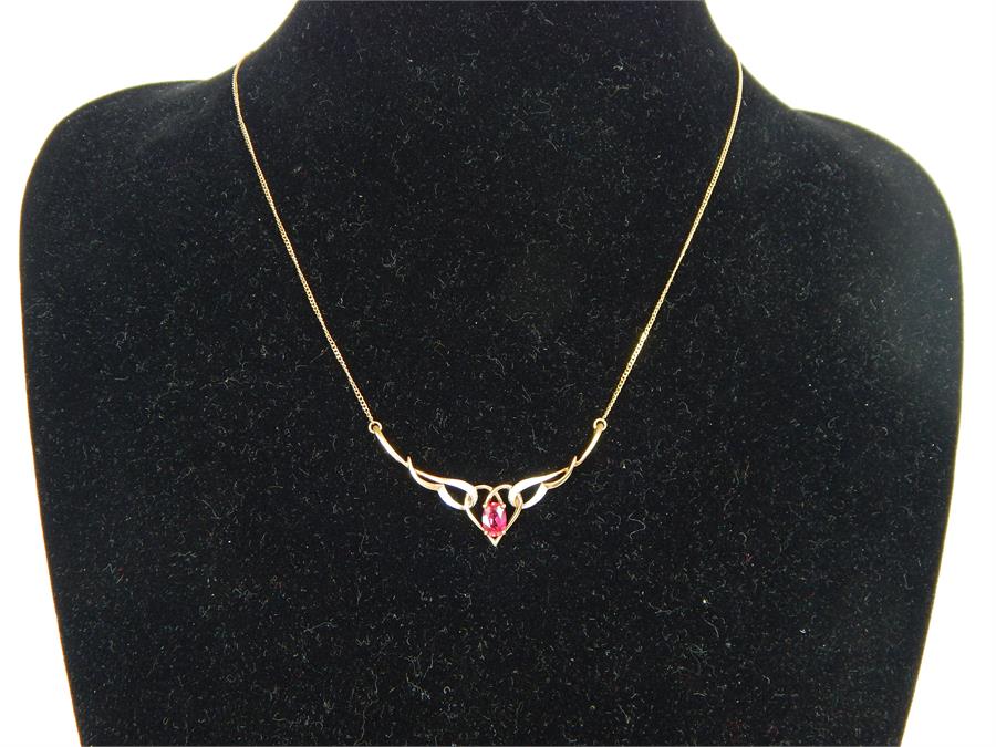 A 9 ct yellow gold, ruby and diamond necklace