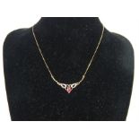 A 9 ct yellow gold, ruby and diamond necklace