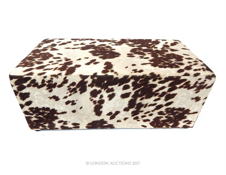 A faux cow skin rectangular stool