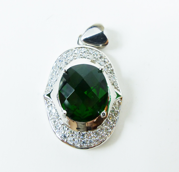A sterling silver, green stone and cubic zirconia pendant