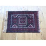 A small Persian rug, 90 x 60cm.