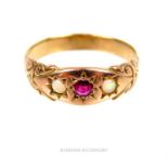 A fine, Victorian, 9 ct yellow gold ring set with a small ruby flanked by two opals