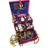 A jewellery box containing costume jewellery and watches