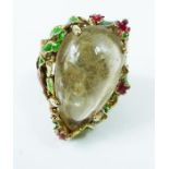 A silver gilt and enamelled ring, set with a pear shaped stone