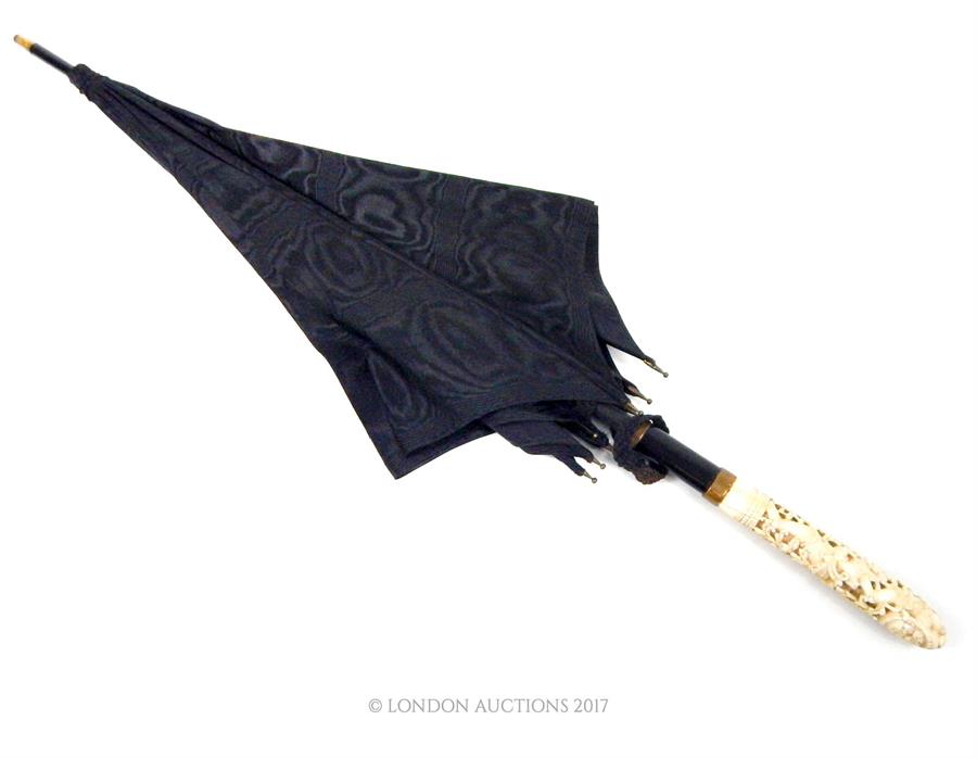 An early 20th century, black silk-satin Edwardian umbrella with fine Burmese Carved Ivory Handle, - Image 3 of 3