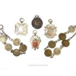 A collection of silver medals, some with enameled detail