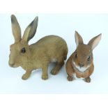 A large, decorative, painted, resin hare and rabbit