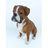 A large, decorative, painted, resin, seated boxer dog