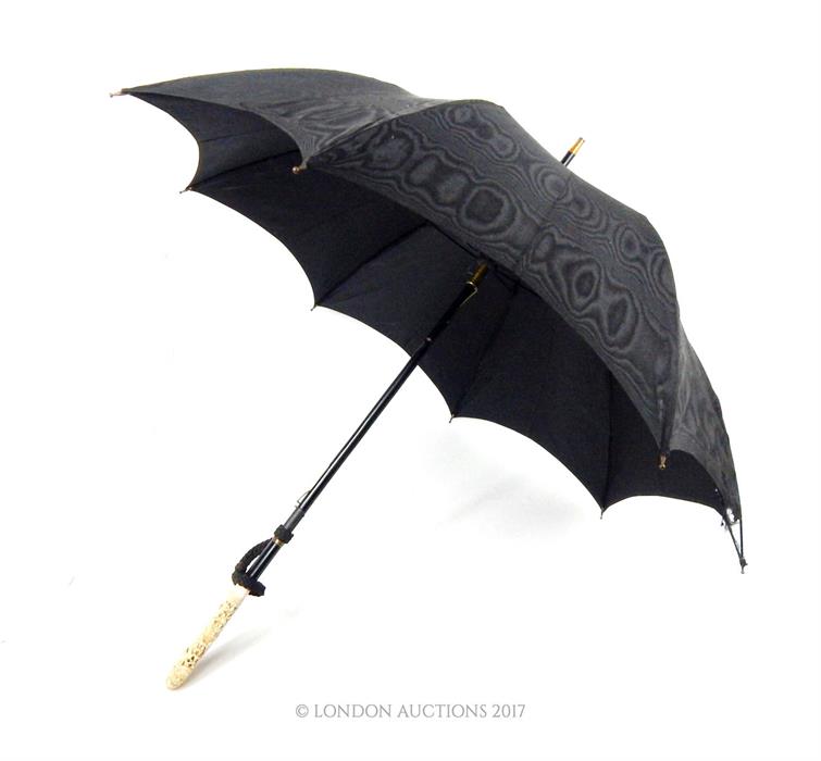 An early 20th century, black silk-satin Edwardian umbrella with fine Burmese Carved Ivory Handle,