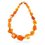 An amber necklace of rough cut beads; 57g.