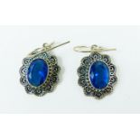 A pair of sterling silver and faceted blue stone earrings