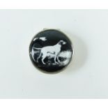 A sterling silver circular pill box, decorated with a dog to the lid