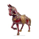 A red painted wooden sculpture of a horse