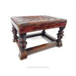 An early 20th century oak footstool, with latticework brown leather seat
