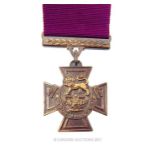 A replica Victoria Cross medal with ribbon.